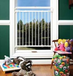 a room with green walls and stuffed animals on the floor in front of an open window