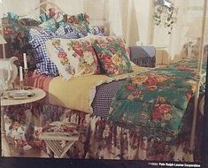 an image of a bedroom setting with flowers on the bedspread and plaid pillows