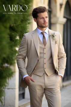 a man in a tan suit and tie standing on the street with his hands in his pockets