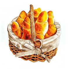 a basket filled with bread sitting on top of a white table next to a ribbon