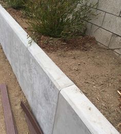 a concrete planter box sitting next to a brick wall