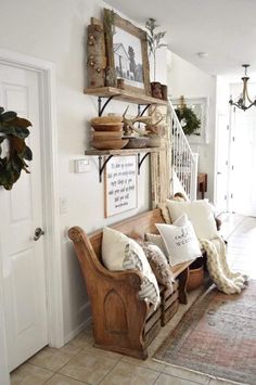 a wooden bench sitting in the middle of a living room next to a white door