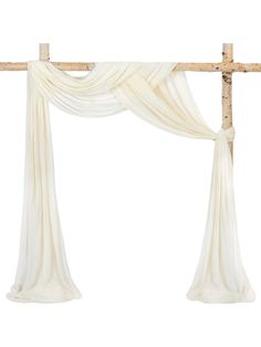 a white curtain hanging from the side of a wooden cross