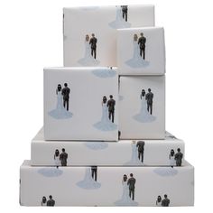 a stack of wedding gift boxes with the bride and groom on them