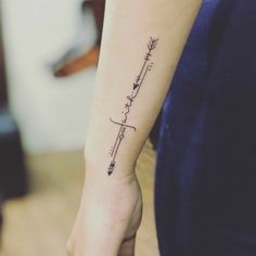 a woman's arm with a tattoo on it that says love and an arrow