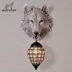 a wolf head mounted to the side of a wall next to a light fixture with lights on it