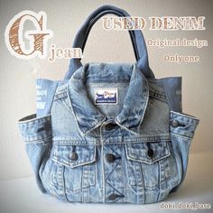 an old jean jacket purse with the words used denim written on it and in front