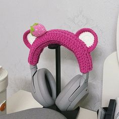 the headphones have ears and are knitted in pink