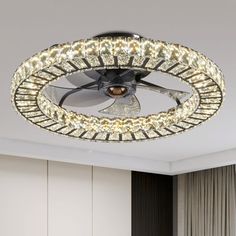 a ceiling fan with lights on it in a room