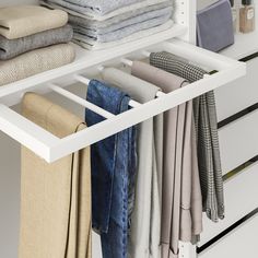 an organized closet with folded clothes and linens