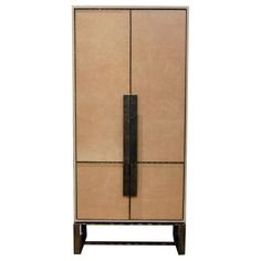 a tall cabinet with two doors and an iron handle