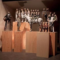 a group of statues sitting on top of wooden blocks