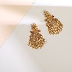 Description Inspired by the shimmering Indian gold jewelry. This Collection is designed to highlight fine Indian craftsmanship. It is crafted in gold-plated 925 silver with intricate textures and tones. Modern designs adorn you with timeless floral patterns. This jewelry is perfect for wedding and festival events. Glistening with festive elegance, these leafy floral silver chandbali earrings are a timeless piece made with traditional Indian design aesthetics. The design features a central floral Elegant Gold Hoop Earrings With Latkans, Elegant Festive Hoop Earrings With Latkans, Elegant Hoop Earrings With Intricate Design For Wedding, Festive 22k Yellow Gold Chandelier Earrings, Elegant Intricate Hoop Earrings For Wedding, Bollywood Brass Chandbalis With Intricate Design, Traditional Chandbali Earrings With Intricate Design, Temple Jewelry Style Gold Plated Drop Bridal Earrings, Traditional Gold Plated Danglers