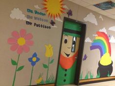 an open door to a classroom with murals on the wall and flowers painted on the walls