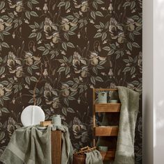 the wall paper is brown with flowers and leaves on it, along with a basket full of dishes