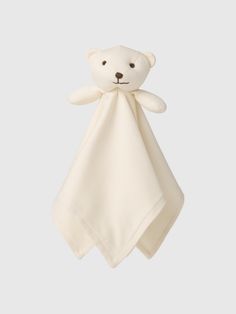 a white teddy bear hanging from the side of a baby's burple