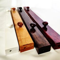 three wooden pieces are lined up on a white surface