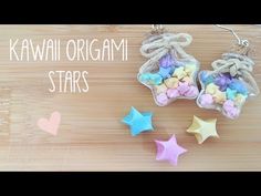 two small stars are next to each other on a wooden surface with the words kawaii origami stars