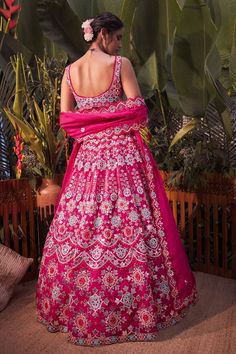 Magenta pink lehenga with mirror work, thread embroidery and foil motifs. Comes with blouse and dupatta.
Component: 3
Pattern: Embroidery
Type Of Work: Mirror, Thread, Gota Patti and Foil
Neckline: Sweetheart
Sleeve Type: Sleeveless
Fabric: Organza
Color: Pink
Other Details: 
Scallop detail on the neckline and hem
Dupatta with scallop and cutwork border
Note: Blue lehenga set worn by the other model is not for sale
Occasion: Bride - Aza Fashions Pink Fitted Dress With Motifs, Wedding Dresses With Motifs, Fitted Wedding Dress With Motifs, Pink Motif Anarkali Set For Wedding, Pink Anarkali Set With Motifs For Wedding, Pink Wedding Anarkali Set With Motifs, Fitted Pink Anarkali Set With Motifs, Pink Wedding Choli With Motifs, Wedding Sets With Pink Motifs