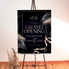 a black and gold grand opening sign on an easel