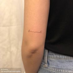 a woman's arm with a small tattoo that says, i love you in cursive writing