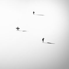 two people walking across a snow covered field