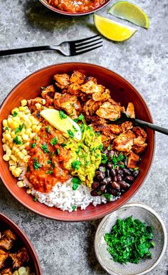 two bowls filled with different types of food and garnished with cilantro