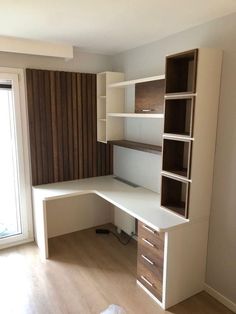 an empty room with a desk and shelves