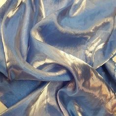 the fabric is shiny and blue in color