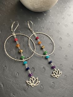 These dainty gemstone Chakra earring is designed with seven different gemstones, each symbolizing the seven energy points in your boyd. Each of the gemstones has its healing powers and is believed to render physical, mental, and spiritual benefits. From bottom to top, this strand includes Ruby, carnelian, pyrite, emerald, turquoise, lapis lazuli and amethyst. ---------------------------------------- *JEWELRY CARD OPTIONS* Please indicate your choice of a message or your personals message in the Silver Hoop Earrings With Natural Stones As Gift, Multicolor Gemstone Hoop Earrings For Gift, Multicolor Natural Stones Hoop Earrings As Gift, Multicolor Hoop Earrings With Natural Stones For Gift, Gift Multicolor Hoop Earrings With Natural Stones, Chakra Jewelry Diy, Diy Gemstone Earrings, Chakra Lotus, Boho Jewlery