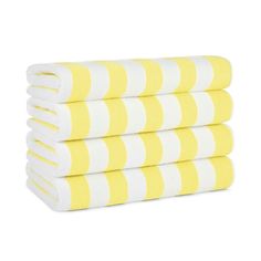 four yellow and white striped towels stacked on top of each other in front of a white background