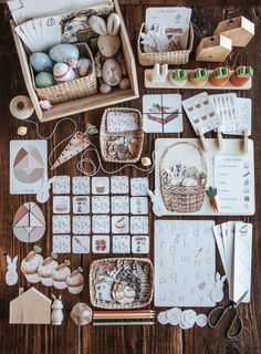 an assortment of crafting supplies laid out on top of a wooden table with scissors and other items