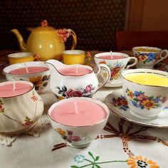 teacups with candles are sitting on a table