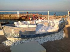 a wooden boat is sitting on the beach