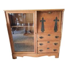 an old wooden cabinet with metal handles and knobs