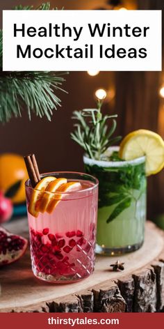 two glasses filled with drinks sitting on top of a wooden table next to christmas decorations