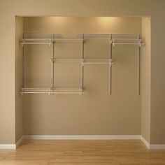 an empty room with shelving and wooden floors