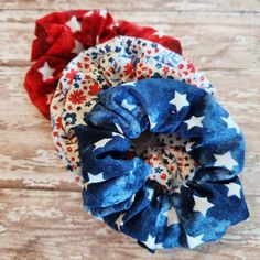 two red, white and blue scrunffles with stars on them sitting on a wooden surface