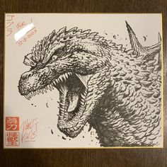 an ink drawing of a godzilla with its mouth open and teeth out, on a piece of paper