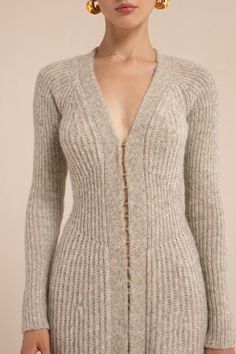 A long-sleeve ribbed knit dress with a v neckline and hook and eye closures down the front. — Midi length — Ribbed knit — Hook and eye front closure — Long sleeve Librarian Chic Outfits, Natural Essence Style, Runway Knitwear, Soft Natural Body, Casual Women Outfits, Librarian Chic, Freakum Dress, Silky Dresses, Long Flowy Skirt