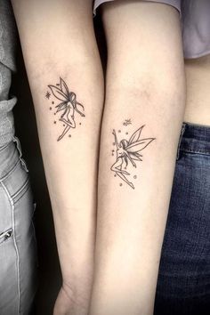 two people with matching tattoos on their arms