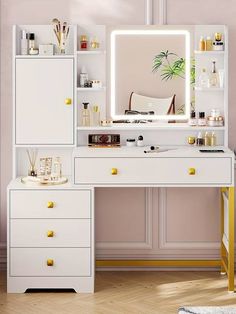 a white desk topped with a mirror and drawers