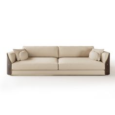 a white couch with two pillows on it's back and one arm facing the camera