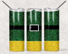 two green and yellow glittered soda cans with straws in each can, one has a black stripe on the side