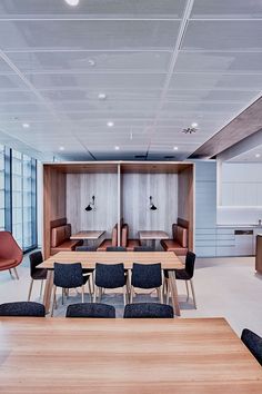 an empty conference room with wooden tables and chairs