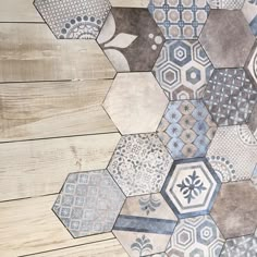 the floor is made up of hexagonal tiles and wooden planks with different patterns