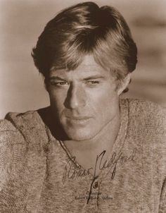 an old black and white photo of a young man with his hair styled in a side part