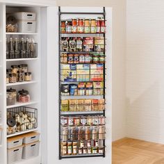 an organized pantry is shown in the corner of a room with white walls and wooden floors