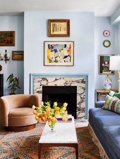 a living room filled with furniture and a fire place in front of a painting on the wall