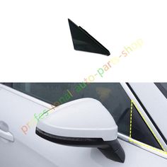 the side view mirror on a white car with an arrow shaped sticker in it